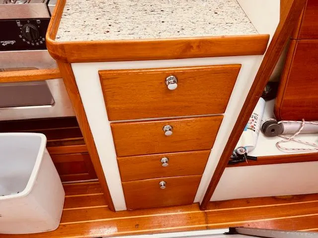 Slide: The Image of Wooden cabinet with four drawers and granite countertop on a 2006 Robert Perry Far Harbour 39. - 35
