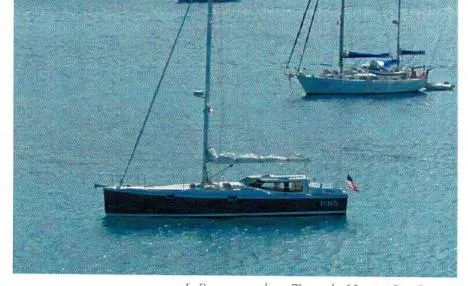 Slide: The Image of Sailboat on calm water, Robert Perry Far Harbour 39, 2006 model, with American flag. - 37