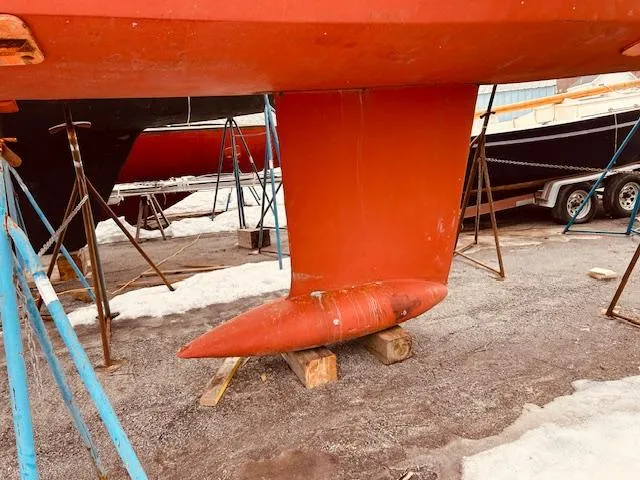 Slide: The Image of Red keel of 2006 Robert Perry Far Harbour 39 sailboat on stands. - 4