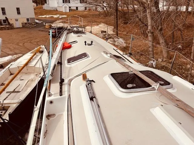 Slide: The Image of Deck view of 2006 Robert Perry Far Harbour 39 sailboat, docked near trees and buildings. - 5