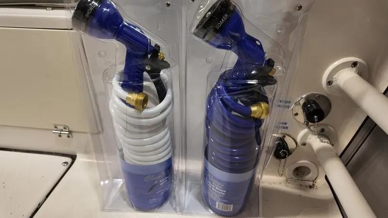 Slide: The Image of Coiled hoses with spray nozzles on a 2024 Sea Born LX 24 LE boat. - 10