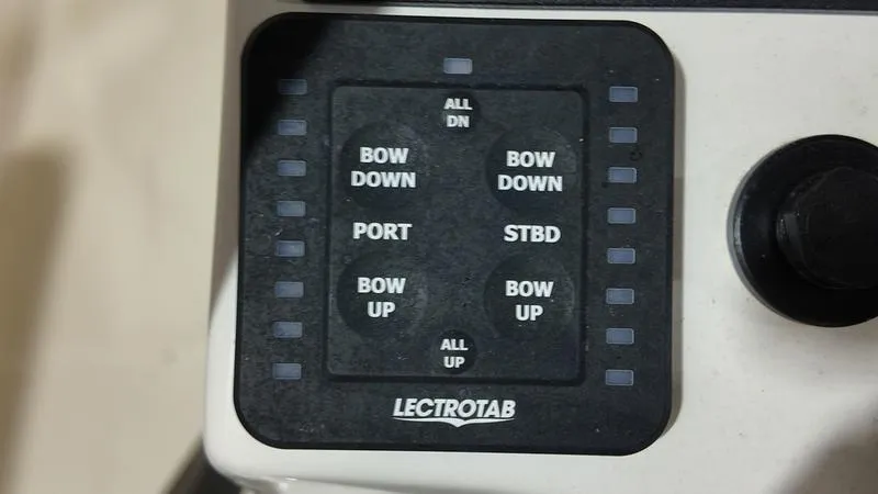 Slide: The Image of Control panel of a 2024 Sea Born LX 24 LE boat with Lectrotab trim tab switches. - 17