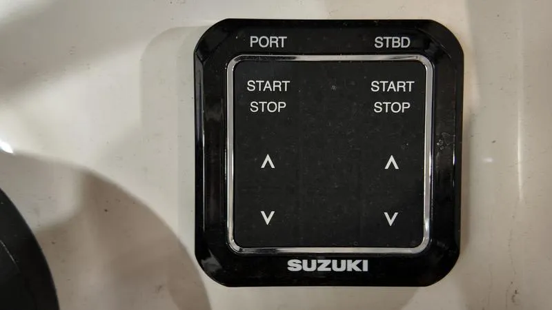 Slide: The Image of Suzuki control panel on 2024 Sea Born LX 24 LE boat, featuring start/stop buttons. - 18