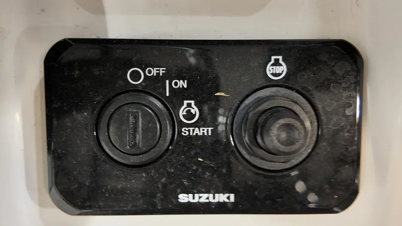 Slide: The Image of Control panel of a 2024 Sea Born LX 24 LE boat with Suzuki start-stop buttons. - 19