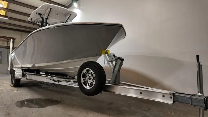 Slide: The Image of 2024 Sea Born LX 24 LE boat on trailer in a garage setting. - 2