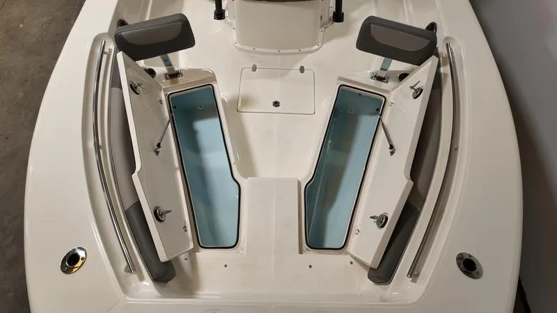 Slide: The Image of 2024 Sea Born LX 24 LE boat with open storage compartments. - 27