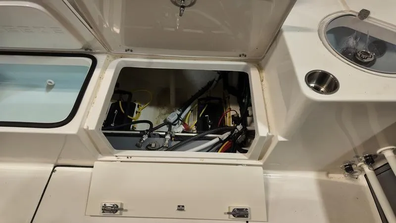 Slide: The Image of 2024 Sea Born LX 24 LE boat storage compartment with wiring and plumbing. - 6