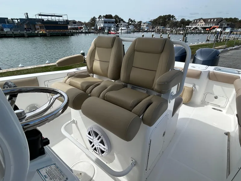Slide: The Image of 2015 Sea Hunt Gamefish 30 boat interior with dual seats and steering wheel. - 13