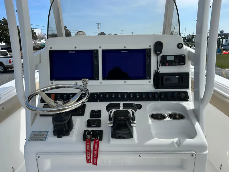 Slide: The Image of 2015 Sea Hunt Gamefish 30 helm with dual displays, steering wheel, and control panel. - 14