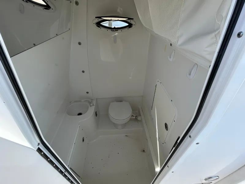 Slide: The Image of 2015 Sea Hunt Gamefish 30 boat interior with toilet and porthole window. - 16