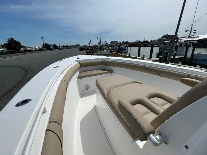 Slide: The Image of 2015 Sea Hunt Gamefish 30 with Coffin Box, docked, showcasing spacious seating and sleek design. - 17