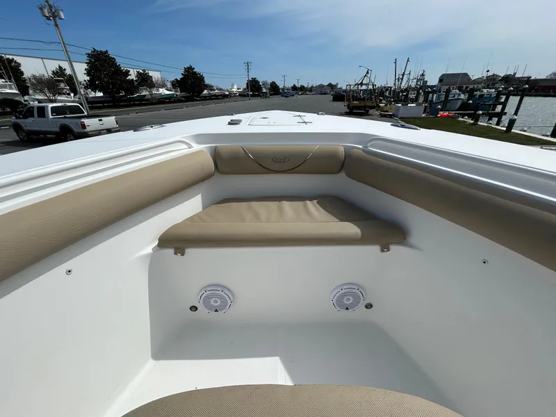 Slide: The Image of 2015 Sea Hunt Gamefish 30 boat interior with cushioned seating and speakers. - 18