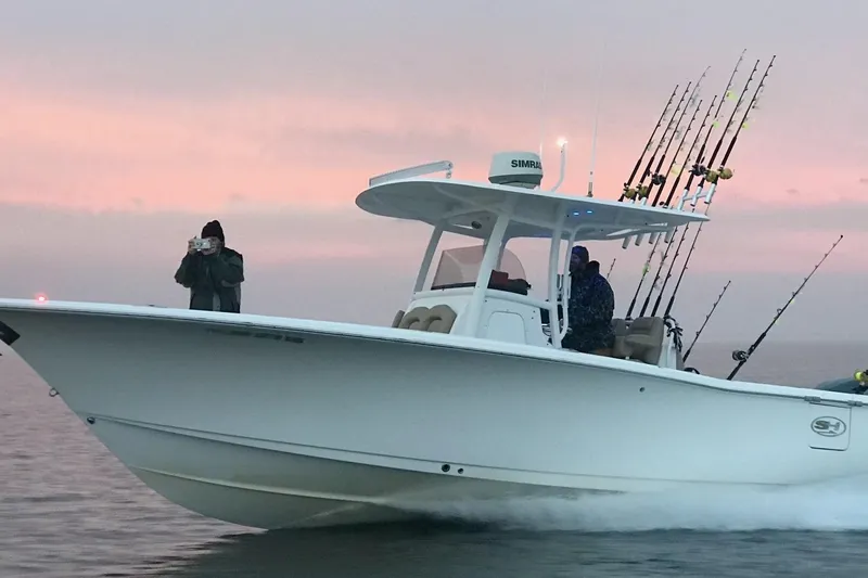 Slide: The Image of 2015 Sea Hunt Gamefish 30 boat with fishing rods at sunset. - 27