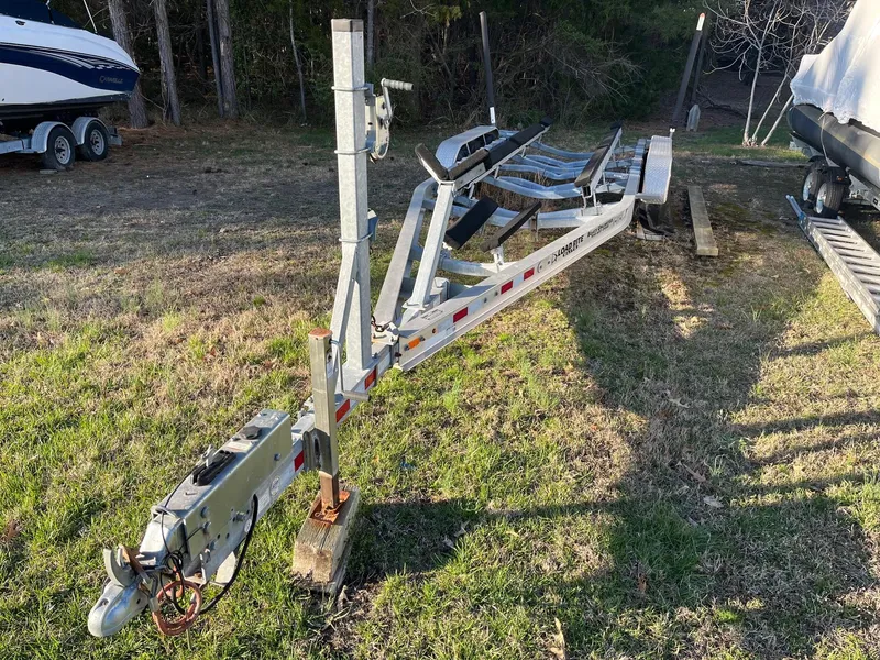 Slide: The Image of Trailer for 2015 Sea Hunt Gamefish 30 with Coffin Box, parked on grass. - 29