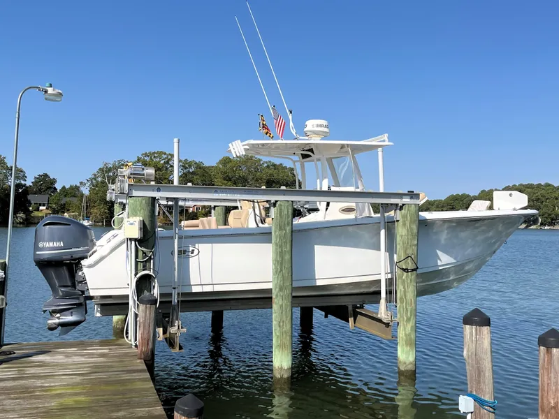 Slide: The Image of 2015 Sea Hunt Gamefish 30 with Coffin Box on a lift at a dock. - 3