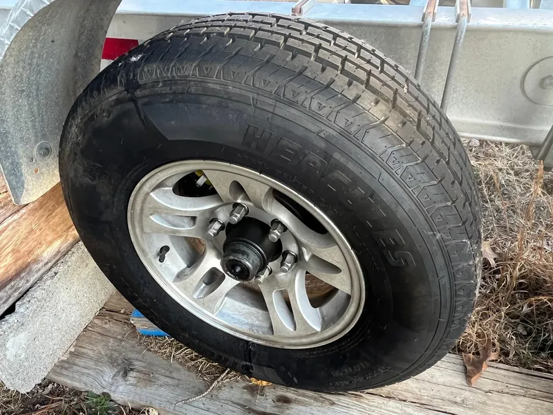 Slide: The Image of Trailer wheel for 2015 Sea Hunt Gamefish 30 with Coffin Box, mounted on metal frame. - 30