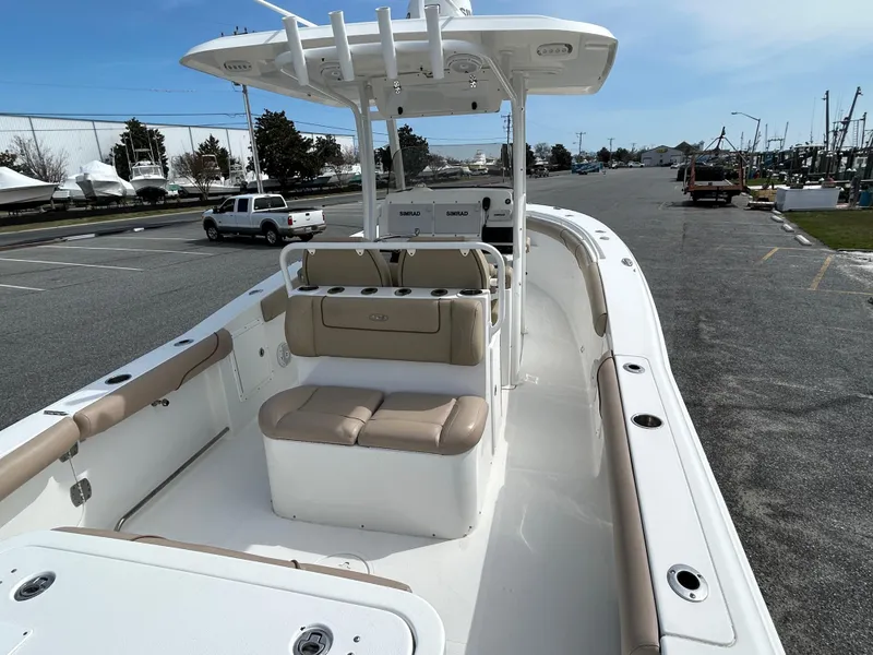 Slide: The Image of 2015 Sea Hunt Gamefish 30 boat with coffin box, parked in a marina lot. - 5