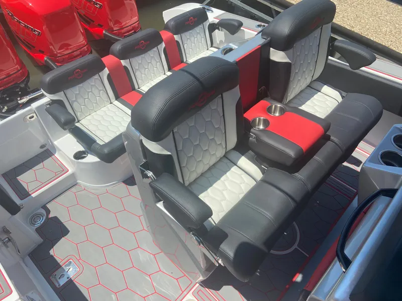 Slide: The Image of 2022 Fountain 38 SC boat interior with black and red seating, cup holders, and hexagonal floor pattern. - 13