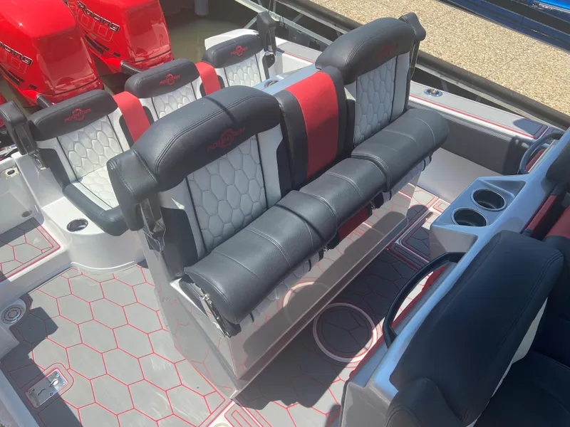 Slide: The Image of 2022 Fountain 38 SC boat interior with black and red seating and cup holders. - 14