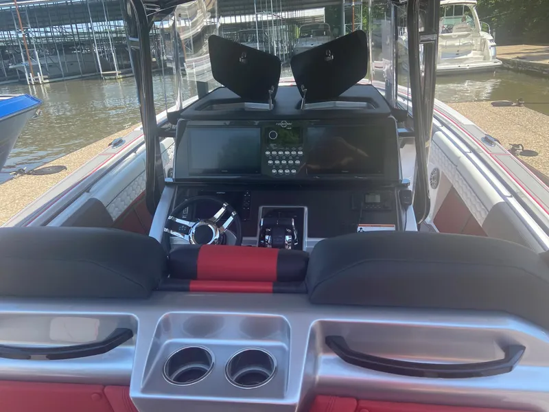 Slide: The Image of 2022 Fountain 38 SC boat cockpit with modern controls and seating. - 17