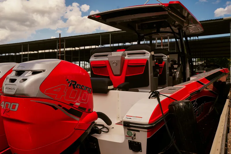 Slide: The Image of 2022 Fountain 38 SC boat with red Mercury Racing 400 outboard engines, docked under a blue sky. - 2