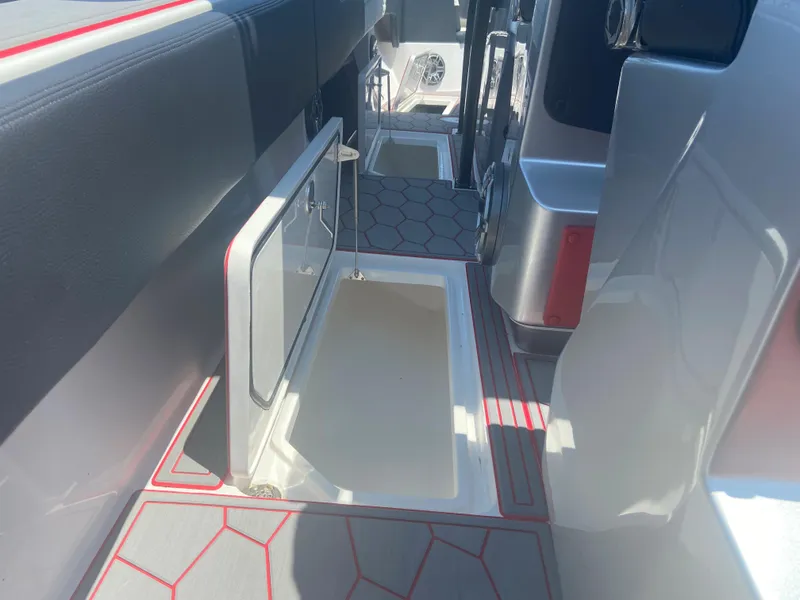 Slide: The Image of 2022 Fountain 38 SC boat interior with open storage compartment and hexagonal floor design. - 21