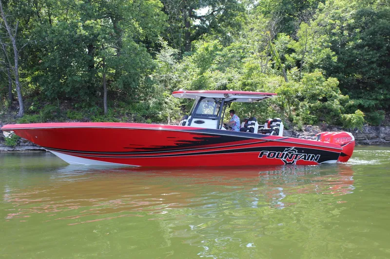 Slide: The Image of 2022 Fountain 38 SC boat in vibrant red on a serene lake. - 4