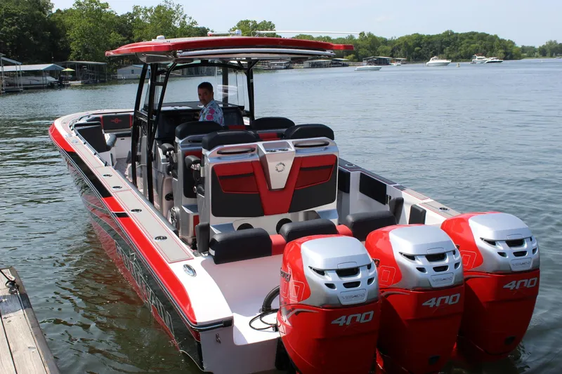 Slide: The Image of 2022 Fountain 38 SC boat with triple 400 horsepower engines on a lake. - 6