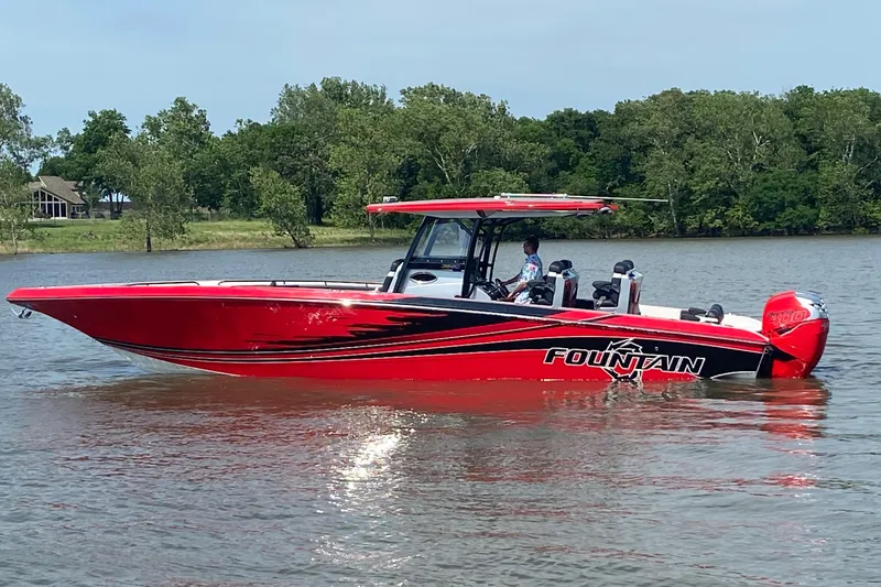 Slide: The Image of 2022 Fountain 38 SC boat in vibrant red on a calm lake. - 8