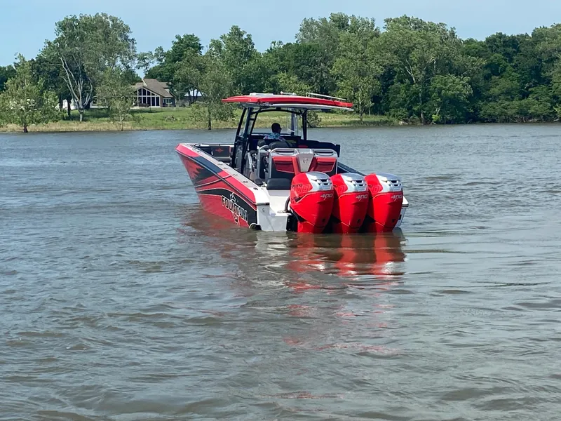 Slide: The Image of 2022 Fountain 38 SC boat with triple engines on a calm lake. - 9