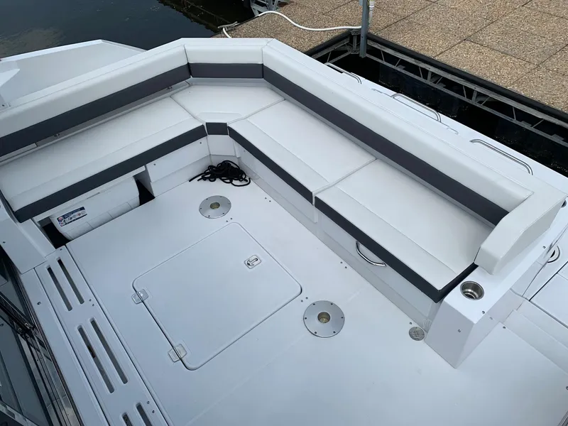 Slide: The Image of 2019 Cruisers Yachts 42 Cantius deck with white seating and storage compartments. - 24