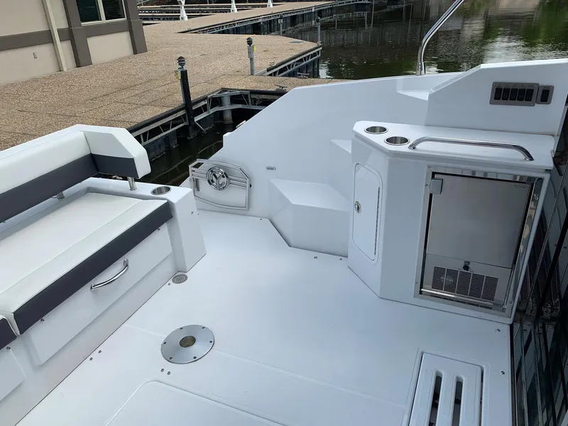 Slide: The Image of 2019 Cruisers Yachts 42 Cantius cockpit with seating and storage, dockside view. - 25