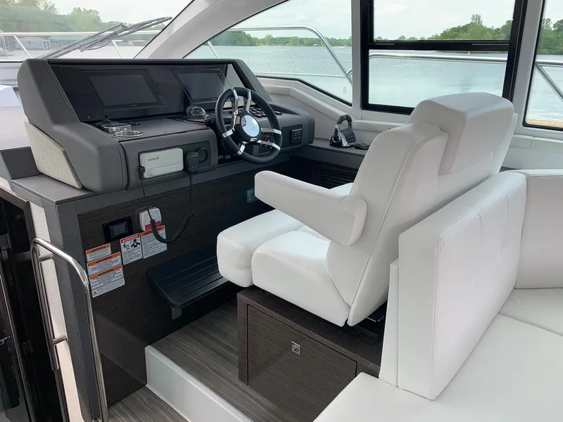 Slide: The Image of 2019 Cruisers Yachts 42 Cantius helm with modern controls and white seating. - 31