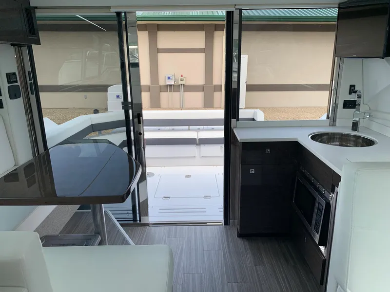 Slide: The Image of 2019 Cruisers Yachts 42 Cantius interior with modern kitchen and dining area. - 34