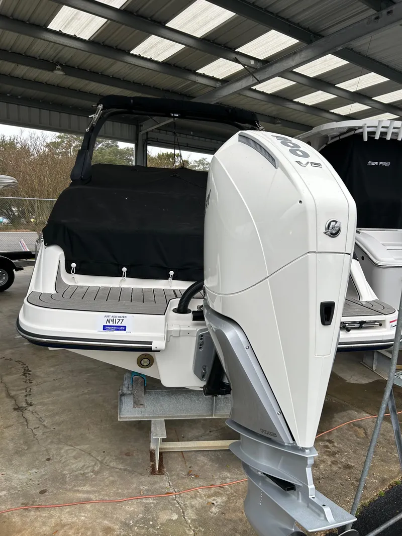 Slide: The Image of 2025 Sea Ray SDX 270 Outboard boat in storage, featuring a powerful outboard motor. - 2