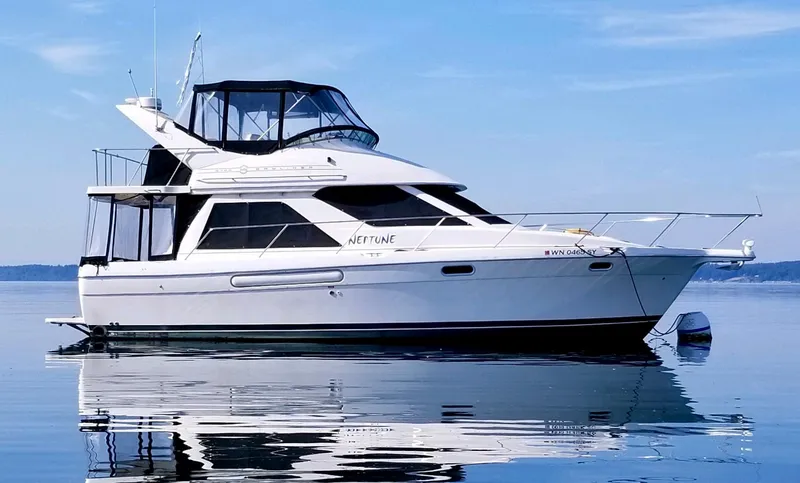 The Image of 1996 Bayliner 3788 Command Bridge Motoryacht on calm water, side view. - 0