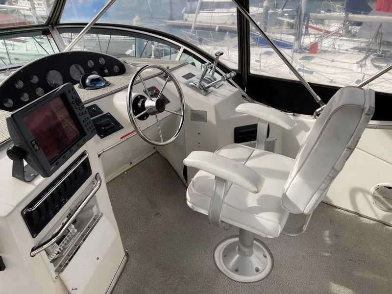 Slide: The Image of 1996 Bayliner 3788 Command Bridge Motoryacht helm with captain's chair and navigation equipment. - 12