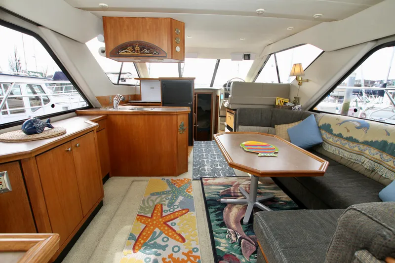 Slide: The Image of Interior of 1996 Bayliner 3788 Command Bridge Motoryacht, featuring cozy seating and nautical decor. - 15