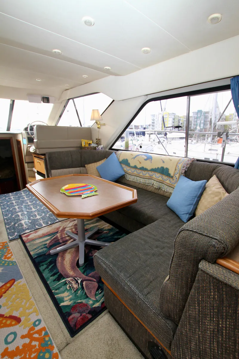 Slide: The Image of Interior of 1996 Bayliner 3788 Command Bridge Motoryacht with cozy seating and large windows. - 17