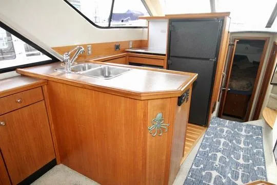 Slide: The Image of Interior of 1996 Bayliner 3788 Command Bridge Motoryacht with kitchen and nautical decor. - 23