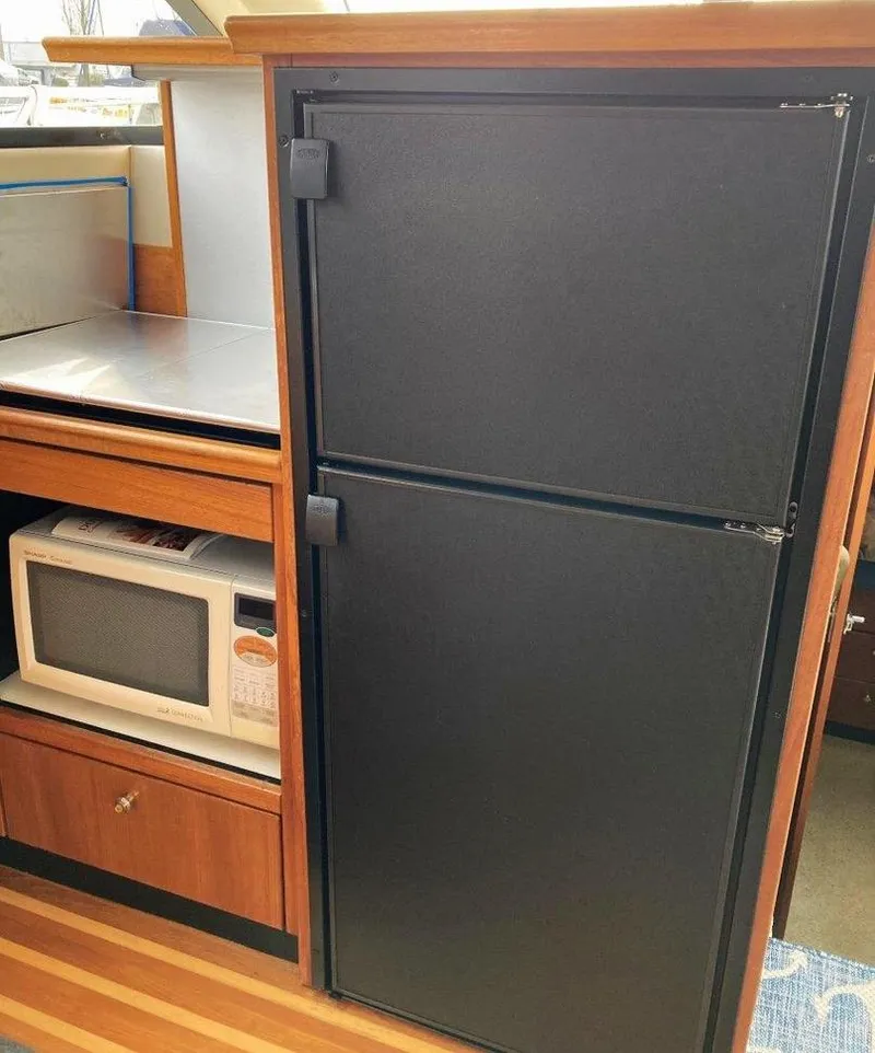 Slide: The Image of 1996 Bayliner 3788 Command Bridge Motoryacht kitchen with fridge and microwave. - 28