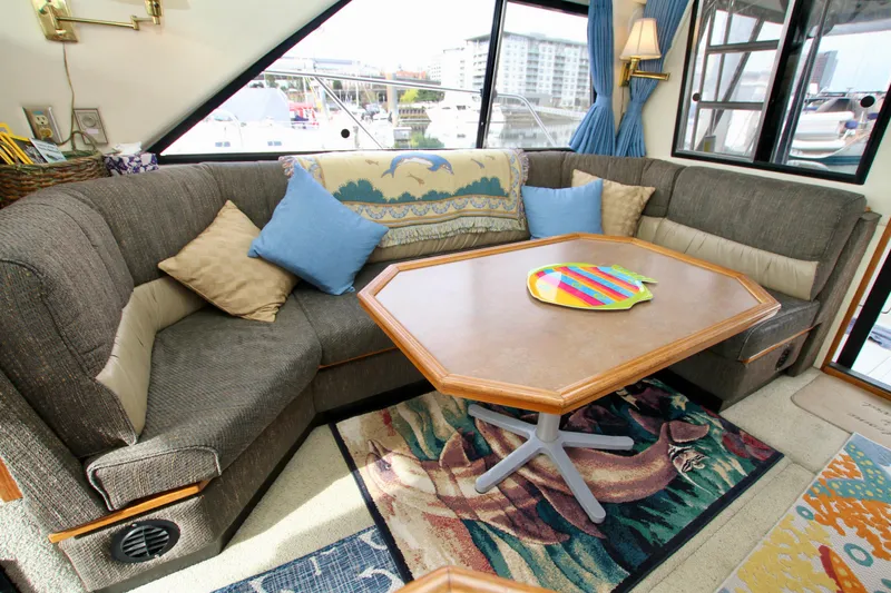 Slide: The Image of Cozy interior of 1996 Bayliner 3788 Command Bridge Motoryacht with plush seating and table. - 29