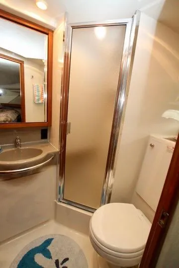 Slide: The Image of 1996 Bayliner 3788 Command Bridge Motoryacht bathroom with shower, sink, and toilet. - 40
