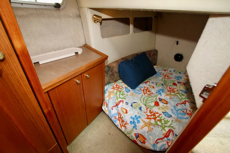 Slide: The Image of Cozy cabin interior of 1996 Bayliner 3788 Command Bridge Motoryacht with colorful bedding. - 43