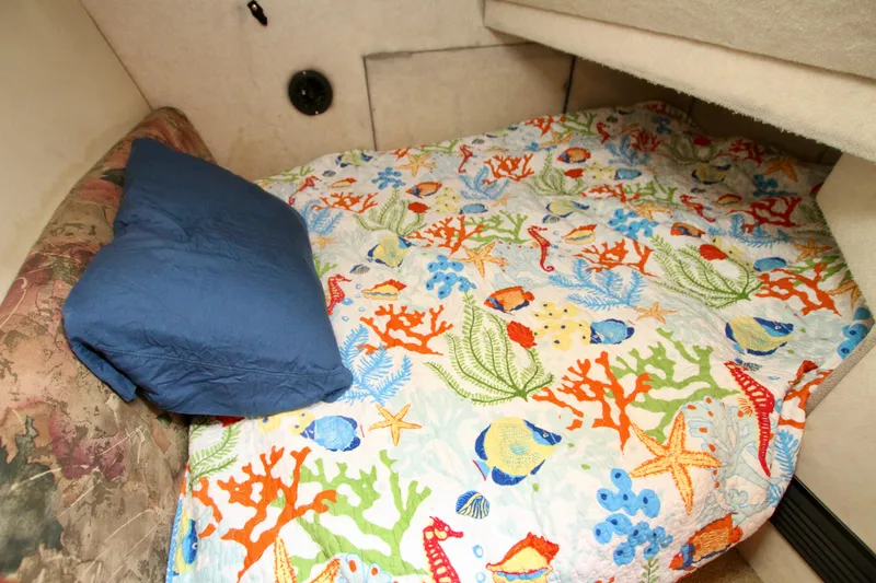 Slide: The Image of Cozy cabin bed in 1996 Bayliner 3788 Command Bridge Motoryacht with colorful marine-themed bedding. - 44