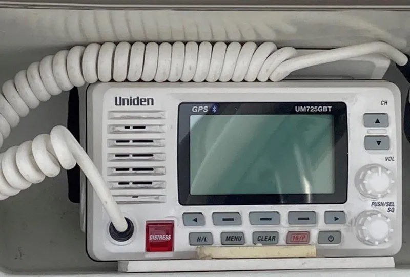 Slide: The Image of Uniden marine radio on 1996 Bayliner 3788 Command Bridge Motoryacht, featuring GPS and distress button. - 46