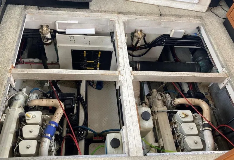 Slide: The Image of Engine room of 1996 Bayliner 3788 Command Bridge Motoryacht, showcasing dual engines and wiring. - 47