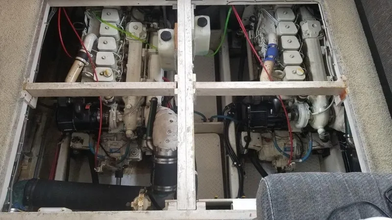 Slide: The Image of Engine compartment of a 1996 Bayliner 3788 Command Bridge Motoryacht, showing dual engines. - 48