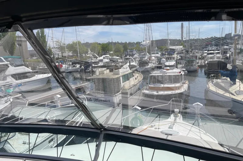 Slide: The Image of Marina view from 1996 Bayliner 3788 Command Bridge Motoryacht, showcasing docked boats and clear skies. - 50