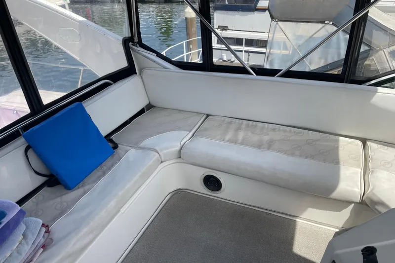 Slide: The Image of Interior seating area of a 1996 Bayliner 3788 Command Bridge Motoryacht with blue cushion. - 51